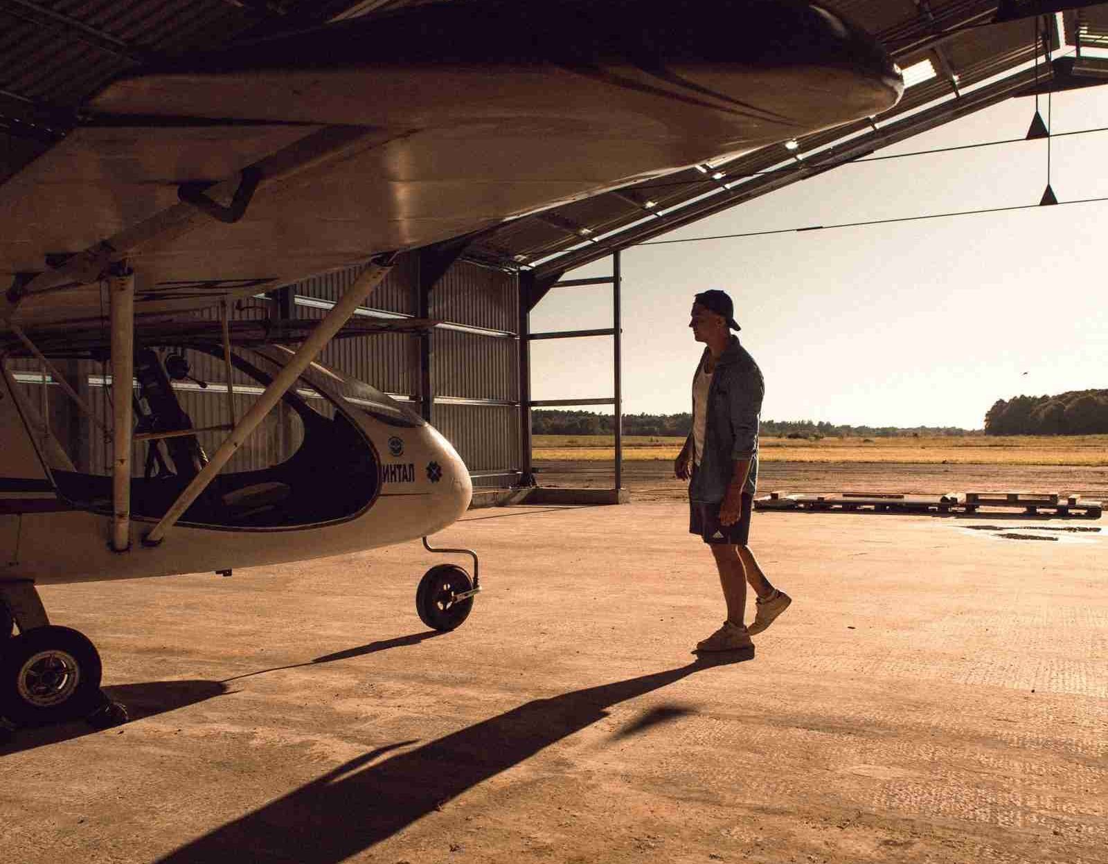 man in airplane hangar